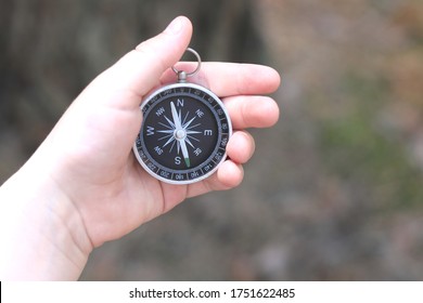 Old classic navigation compass in childs hand on natural background - Shutterstock ID 1751622485