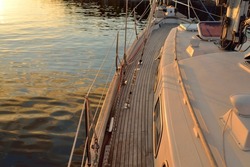 Old Classic Sailboat With Wooden Teak Deck Moored To A Pier In A Yacht Marina At Sunset. Vacations, Transportation, Sport, Recreation, Tourism, Cruise, Port Service
