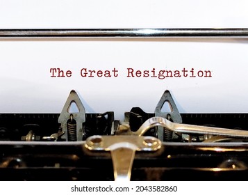 Old classic vintage typewriter with typed text THE GREAT RESIGNATION, a mass voluntary exodus from the workforce - millions workers are quitting their jobs. - Shutterstock ID 2043582860