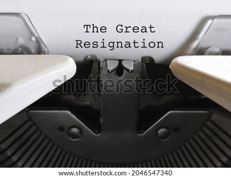 Old classic vintage typewriter with typed text THE GREAT RESIGNATION, a mass voluntary exodus from the workforce - millions workers are quitting their jobs.