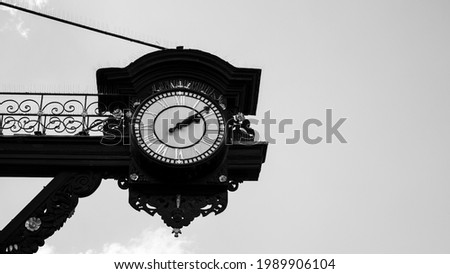 Old Clock In England, UK. Black and white street photography. Historic image of an old Clock