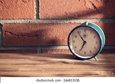 The old clock in front of a brick wall - Powered by Shutterstock