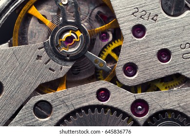 Old clock mechanism with gears and cogs. Macro photo; Abstract background; Closeup view