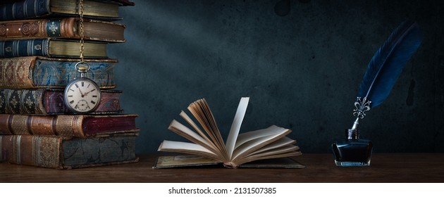 Old clock on background of old books an open book and a fountain pen in an inkwell. Сlock as a symbol of time books are symbol of knowledge. Concept on the theme of history, nostalgia, culture.  - Shutterstock ID 2131507385