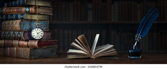 Old clock on background of old books an open book and a fountain pen in an inkwell. Ð¡lock as a symbol of time books are symbol of knowledge. Concept on the theme of history, nostalgia, culture.  - Shutterstock ID 2160814749