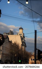 Old clock tower with blue and cloudy sky in the middle of the city