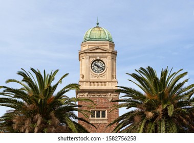 Old clock tower shrouded with palm trees, Melbourne - Powered by Shutterstock