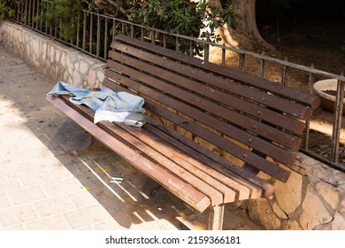 Old Clothes Left On The Bench On The Street Of Tel Aviv, Israel. The Culture Of Second Hand. Old Staff For New Owners.