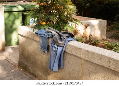 Old Clothes Left On The Street In Tel Aviv, Israel. The Culture Of Second Hand. Old Staff Near Garbage Beans.