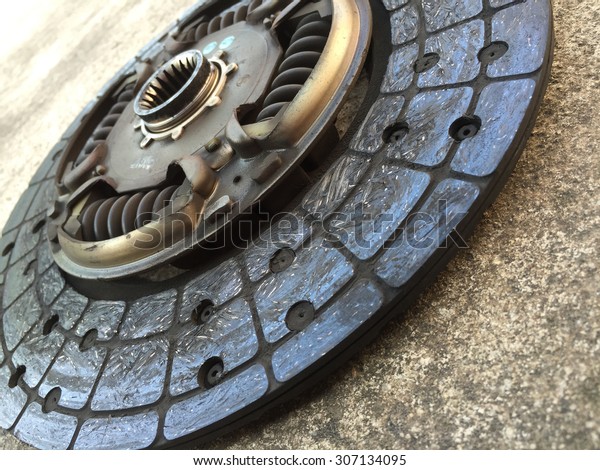 Old clutch disc on a\
cement background