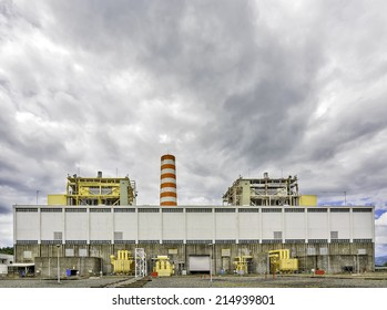 Old Coal Power Plant In Asia Shot Against Ominous Dark Clouds