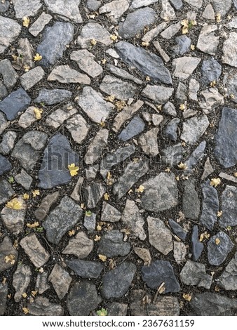 Old cobblestone road top aerial drone view,historical old street in central european town,old pavement structure,abstract cobblestones textures
