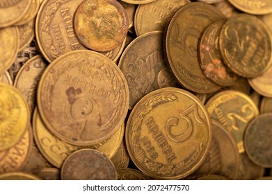 Old coins out of circulation in bulk, background image, close-up, selective focus