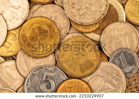 Old coins of the USSR in bulk on a flat surface, background image. Close-up, selective focus.