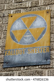 Old cold war "Fallout shelter" sign on a brick wall