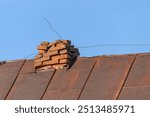 An old collapsed, destroyed chimney on the roof