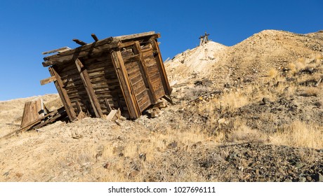 Old Collapsed Wooden Ore Bin At Nevada Gold Mine In Desert.  Ore Hopper And Tailings Pile.