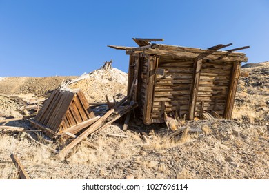 Old Collapsed Wooden Ore Bin At Nevada Gold Mine In Desert.  Ore Hopper And Tailings Pile.