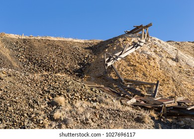 Old Collapsed Wooden Ore Bin At Nevada Gold Mine In Desert.  Ore Hopper And Tailings Pile.