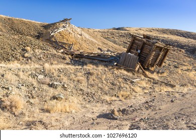 Old Collapsed Wooden Ore Bin At Nevada Gold Mine In Desert.  Ore Hopper And Tailings Pile.