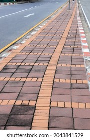 Old Color Long Paved Brick Footpath, Brick Path Or Sidewalk With Perspective Going Into The Distance,  Abstract Background Of Tiles, Footpath, Sidewalk.