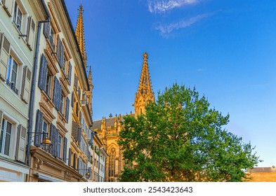 Old colorful buildings walls with shutter windows, typical multicolored houses and Temple Saint-Etienne Mulhouse Cathedral bell tower in old town Mulhouse city historic centre, Alsace, France - Powered by Shutterstock