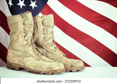 Old combat boots with American flag in the background. Vintage filter effects. - Powered by Shutterstock