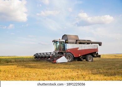 old combine harvester harvests from the field
