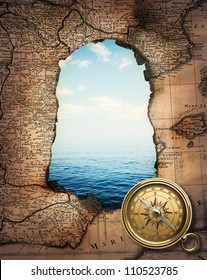 Old compass on vintage burned-down map opens a view of the sea. Ready design on the subject of adventures, pirates