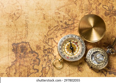 Old compass on vintage map. Retro stale