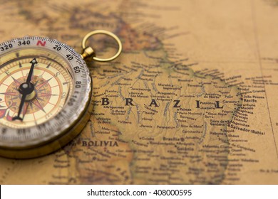 Old compass on vintage map selective focus on Brazil