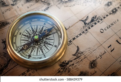 Old compass on vintage map. Retro style - Shutterstock ID 588439379