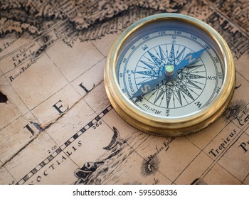 Old compass on vintage map. Retro style - Shutterstock ID 595508336