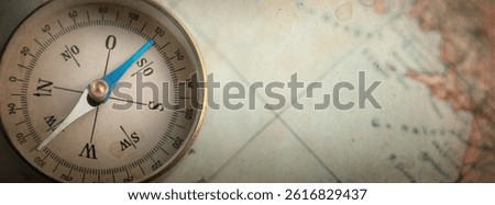Old compass on world map. Travel, geography, history, navigation, tourism and exploration concept background. Overlay effect. on old paper. ttexture.