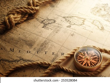 old compass and rope on vintage map 