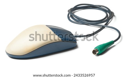 old computer mouse with ps2 connector or port, two button early mouse which used rubber balls on the underside to track movement, isolated on white background