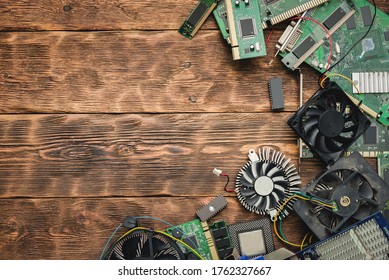 Old Computer Parts On A Brown Wooden Table Flat Lay Background With Copy Space.