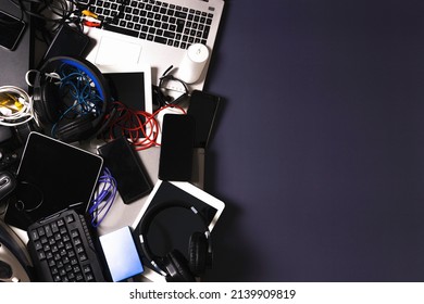 Old Computers, Digital Tablets, Mobile Phones, Many Used Electronic Gadgets Devices, Broken Household And Appliances On Gray Background. Planned Obsolescence, Electronic Waste For Recycling Concept