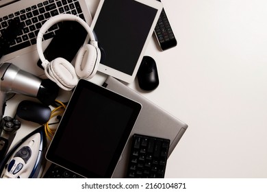 Old computers, digital tablets, mobile phones, many used electronic gadgets devices, broken household and appliances on white background. Planned obsolescence, electronic waste for recycling concept - Shutterstock ID 2160104871