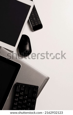 Old computers, digital tablets, mobile phones, used electronic gadgets devices on white background. Planned obsolescence, electronic waste for recycling concept. Top view