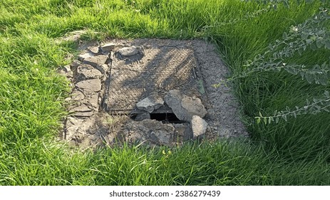 old concrete manhole cover, rainwater grate