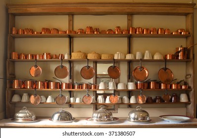 Old copper  pots and pans on kitchen shelf