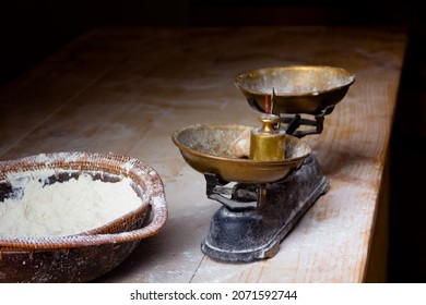 Old copper scales with flour stand on a wooden table in a bakery for bread