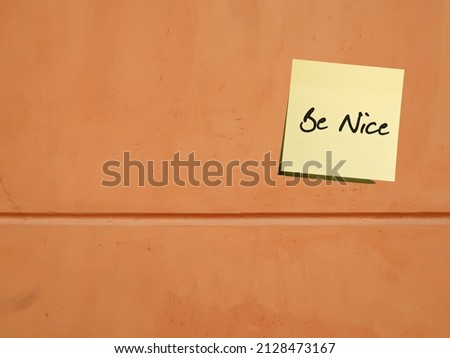 Old copy space wall with text on sticky note BE NICE- concept of treat other people with respect, making others feel good and pave way to good relationship