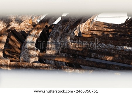 Old coroded rusty anchors stored in maritime industrial harbour on concrete.