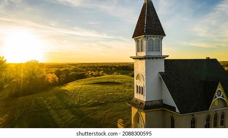 An old country church in the Great Plains during sunset with fall colors in North Dakota.