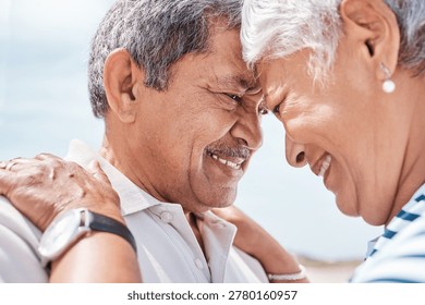 Old couple, affection and touch with forehead at beach with smile, care or bonding on summer vacation. Elderly man, happy woman and trust with loyalty, relationship and retirement on seaside holiday