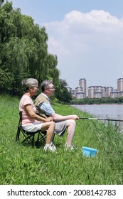 Old Couple Fishing By The Lake High Quality Photo