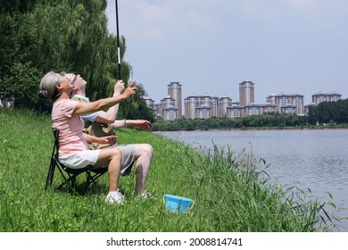 Old Couple Fishing By The Lake High Quality Photo