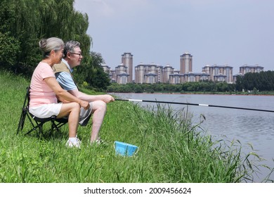 Old Couple Fishing By The Lake High Quality Photo